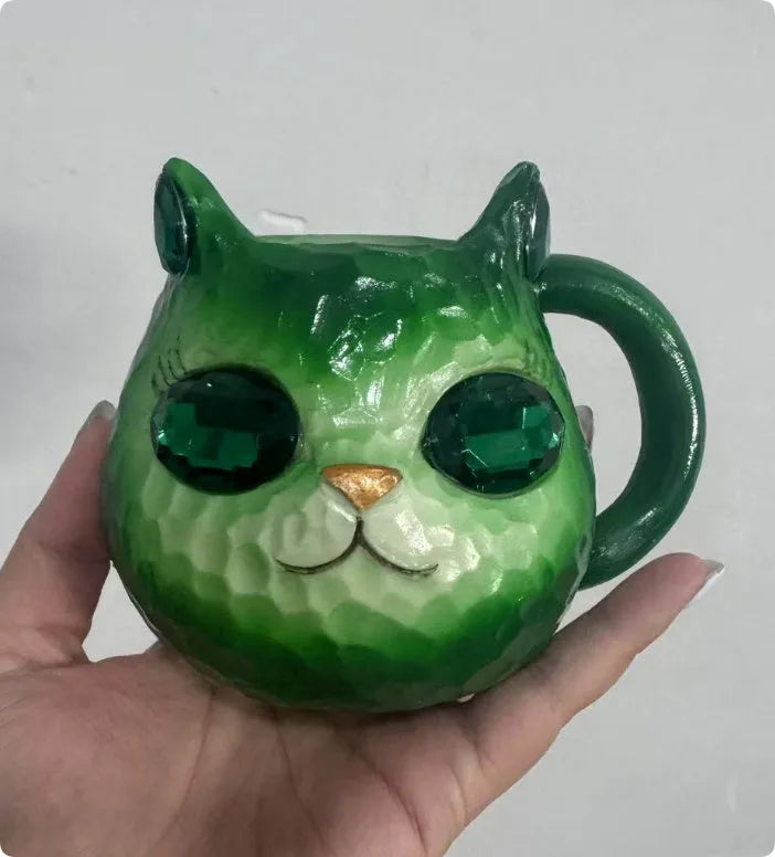 Colourful resin cat cup figurine on a shelf, shown in purple, green, blue, and pink colour options.