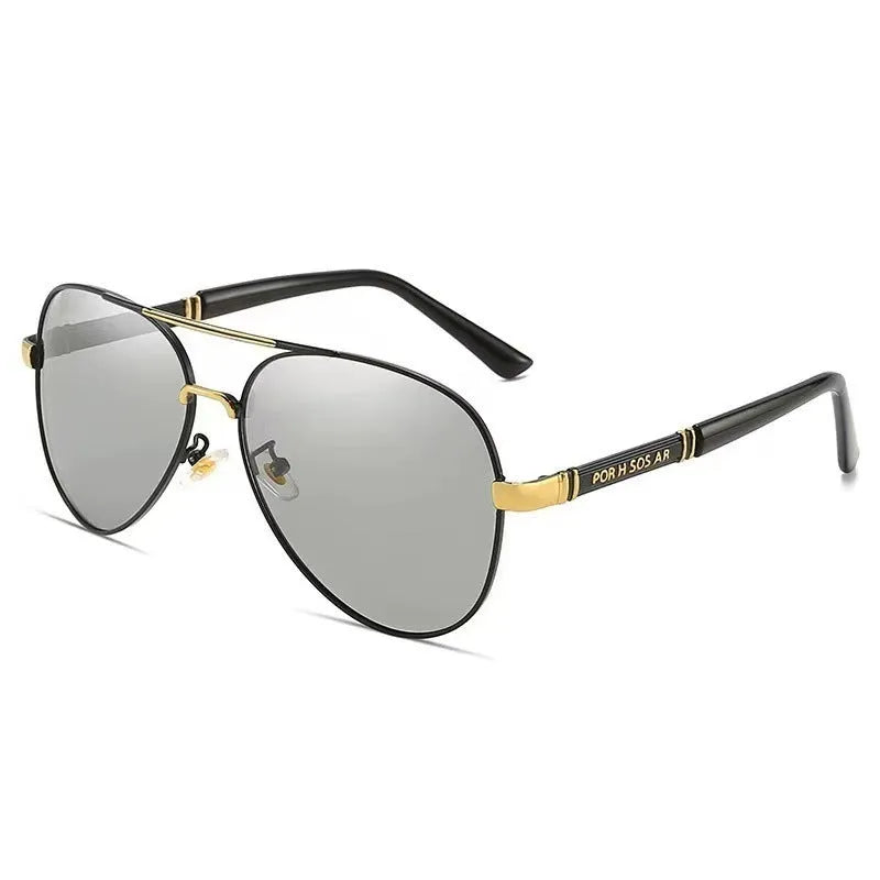 Gold metal frame polarised sunglasses with grey lenses on a table, showing dragon and phoenix temple detail.