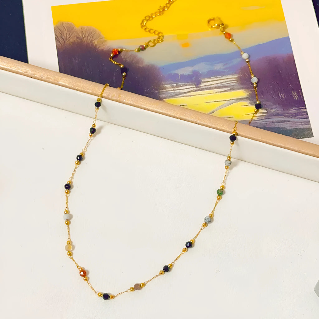 Gold coloured titanium steel necklace with an O-ring chain and a natural stone pendant.