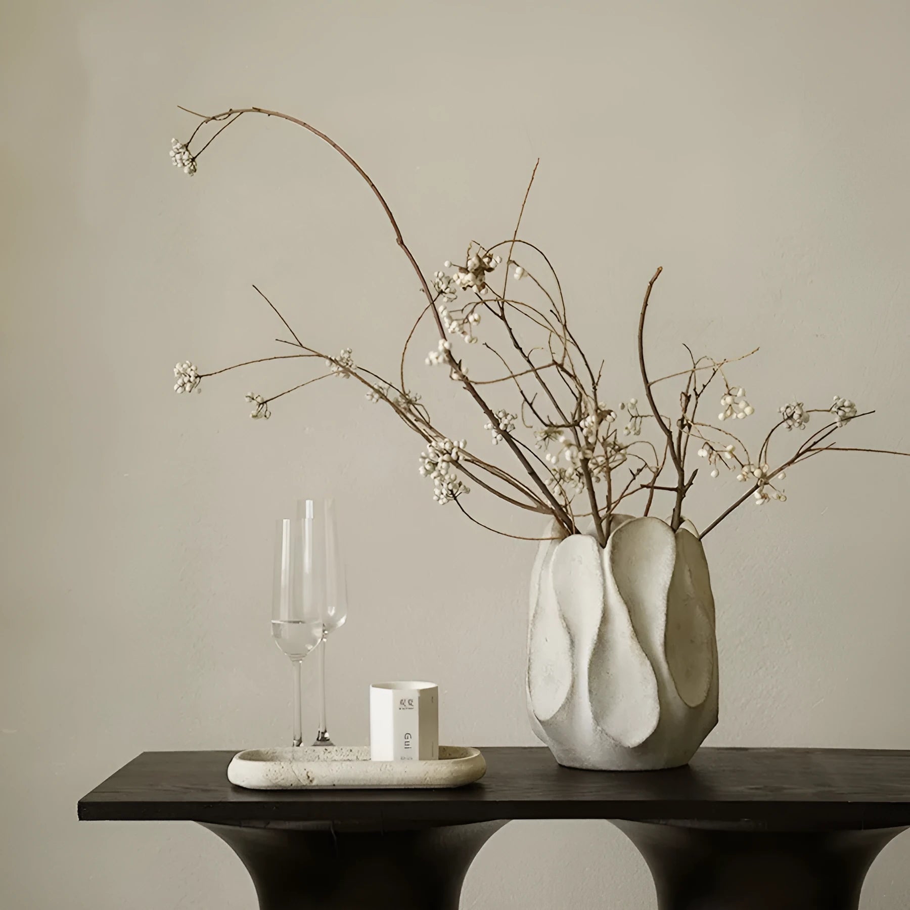 Irregular shaped ceramic art vase for flower arrangements on a desktop.