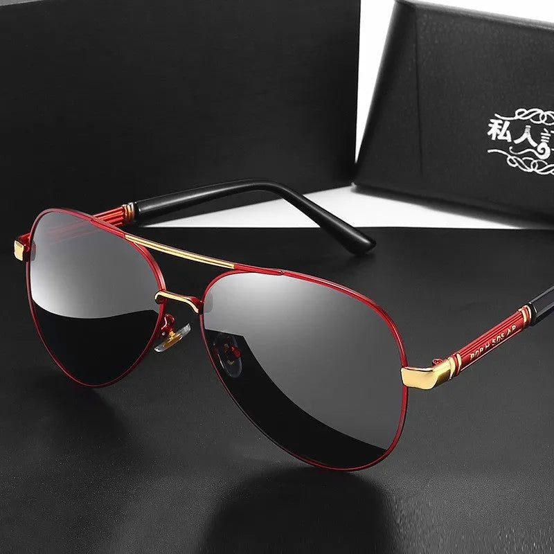Gold metal frame polarised sunglasses with grey lenses on a table, showing dragon and phoenix temple detail.