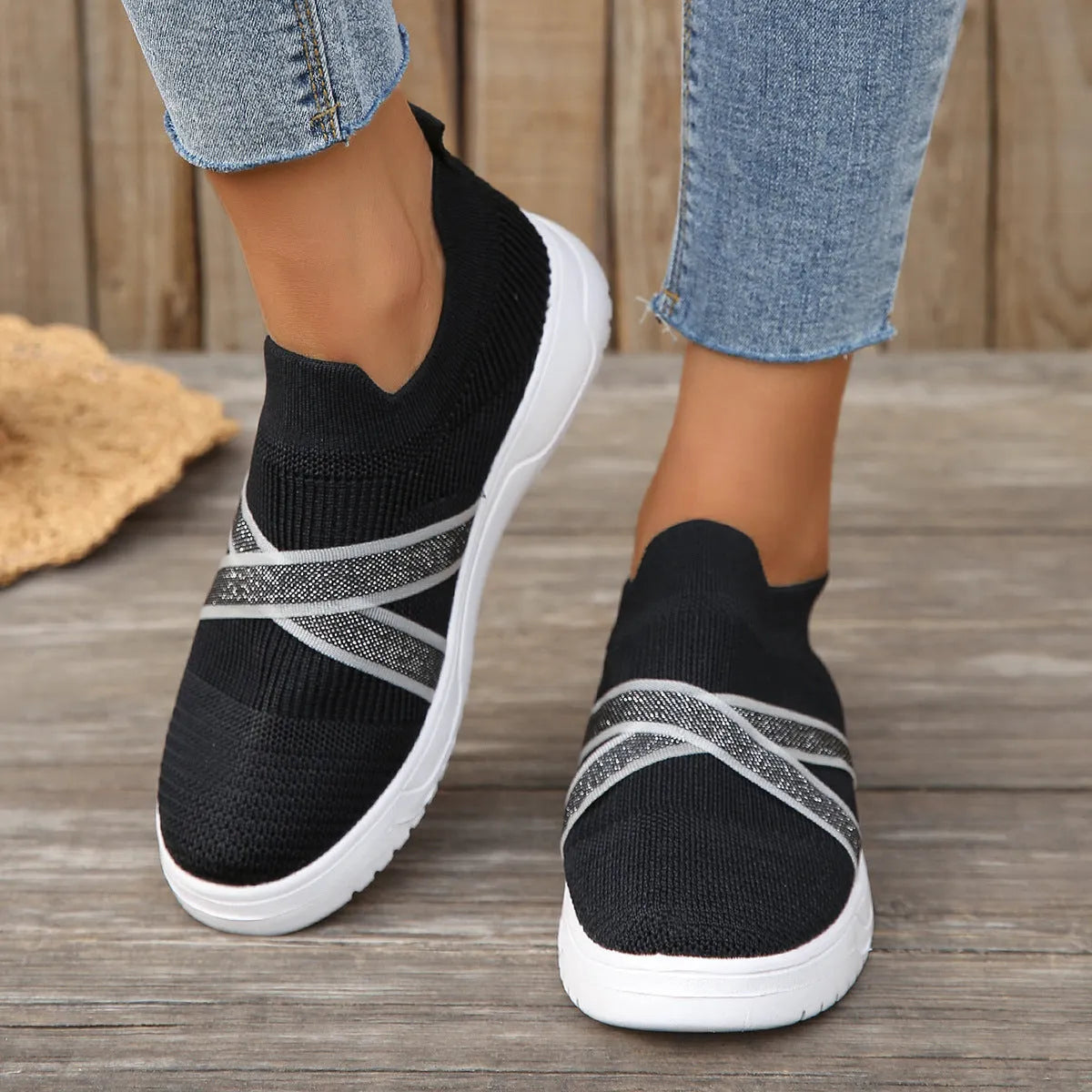 Black women's flyknit mesh shoes with flat rubber sole and tassel detail