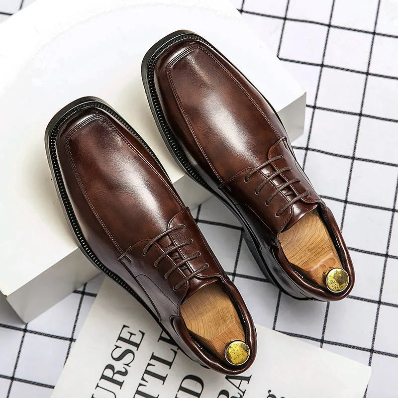 Men's black square toe low-top business casual shoes with a rubber sole.