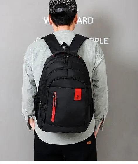 Blue Oxford fabric school backpack with padded black shoulder straps and side pockets.