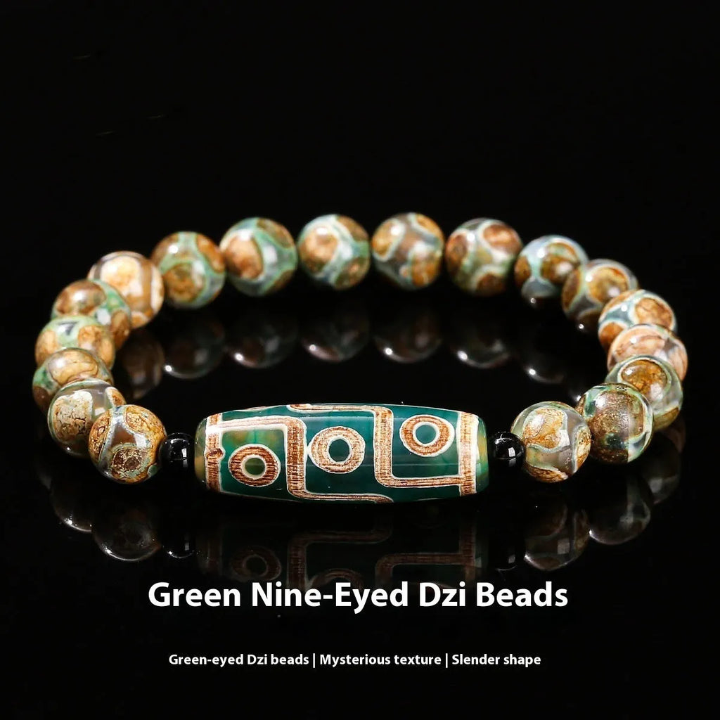 Handmade green dzi bead barrel bracelet with 8mm round geometric beads on a wrist.