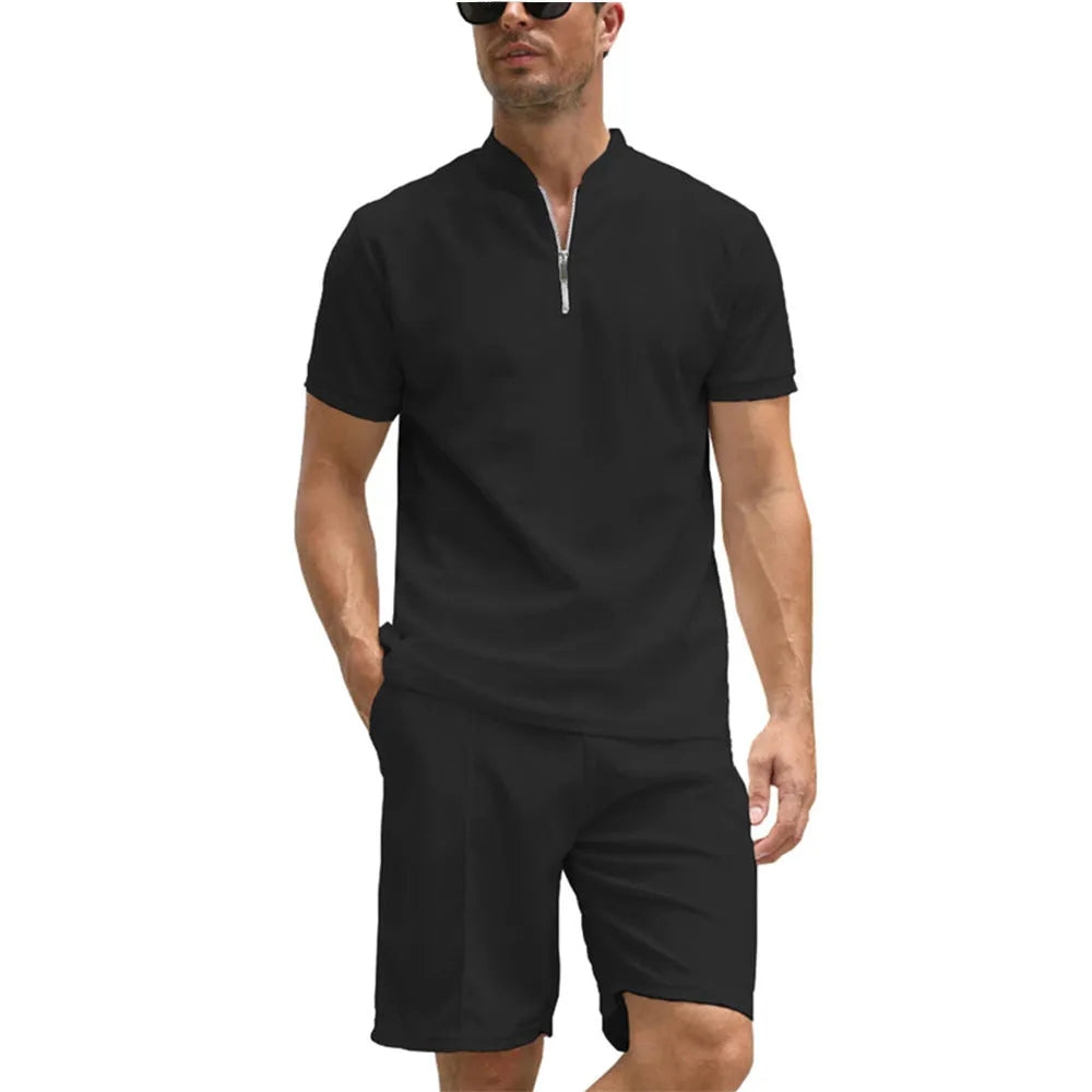 Men's solid colour polo shirt and trouser two-piece set in textured fabric.