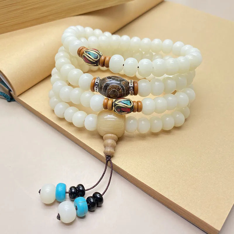 White Jade Bodhi bead bracelet with 108 beads, showing three different carved pattern styles.