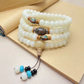 White Jade Bodhi bead bracelet with 108 beads, showing three different carved pattern styles.