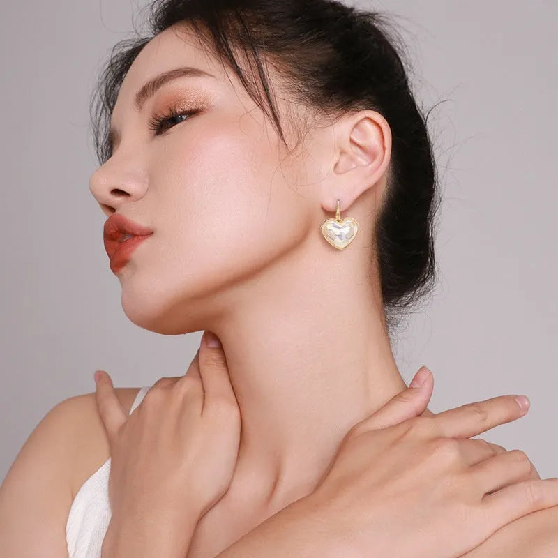 A pair of gold coloured alloy clip-on ear clip earrings for women.