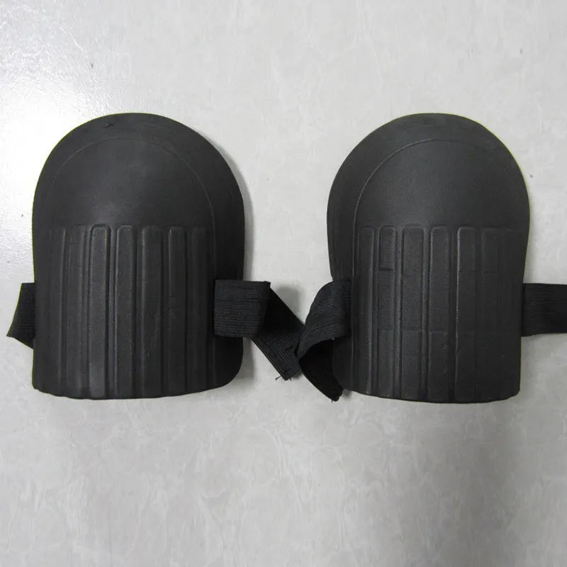 A pair of rectangular EVA foam knee pads in army green colour on a garden soil background.