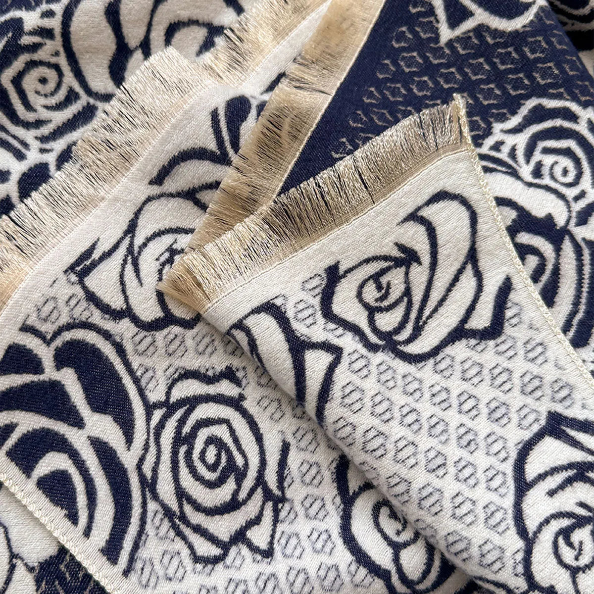 Long grey imitation cashmere winter scarf with tassel fringe on a neutral background.