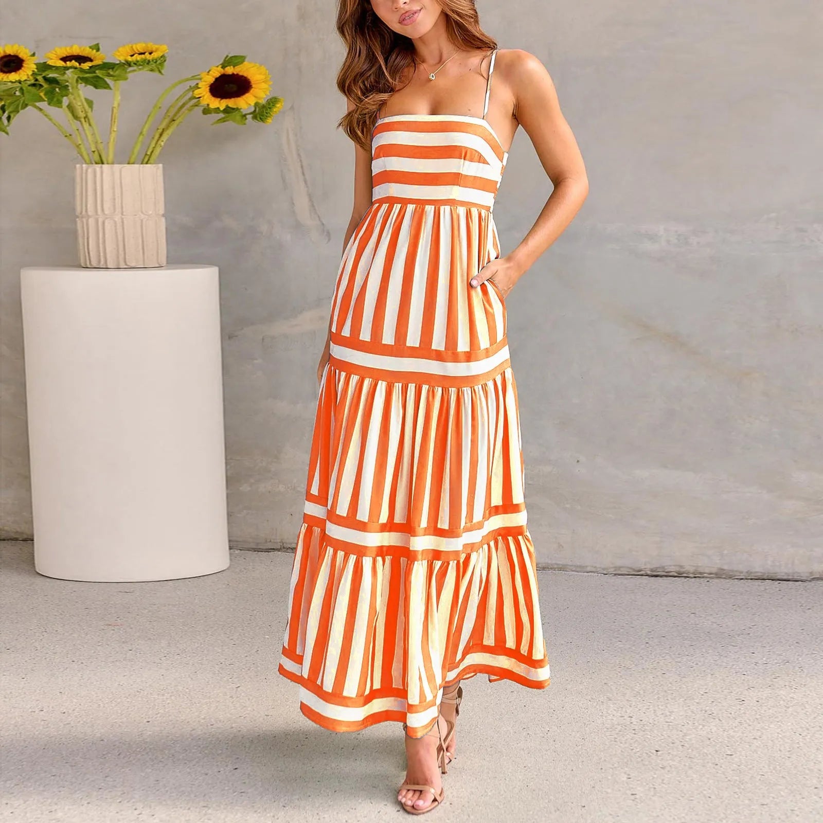 Long striped backless summer dress with square neckline and side pockets on a mannequin