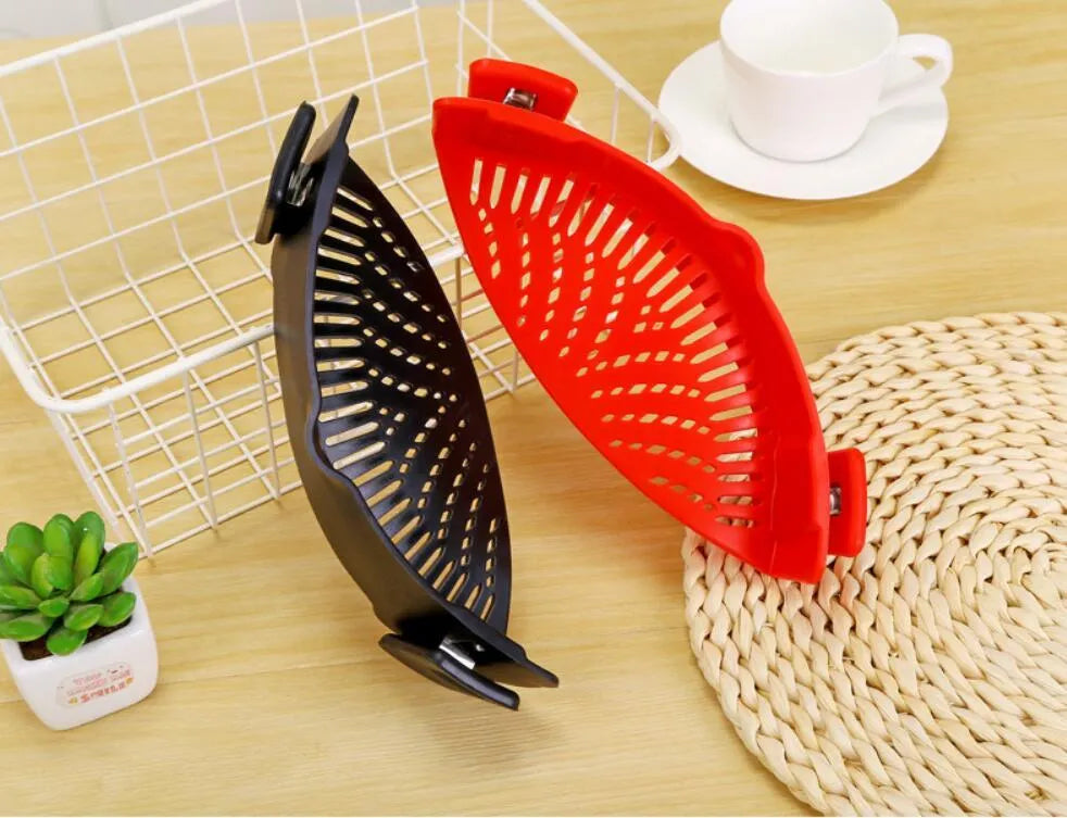 Silicone clip-on funnel strainer attached to a pot rim for draining liquids.