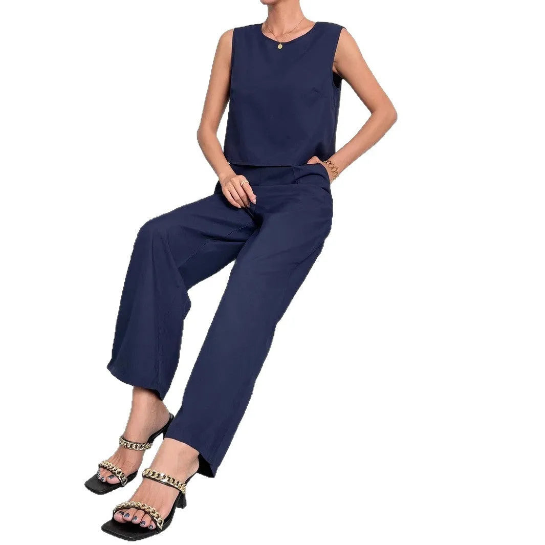Red women's sleeveless top and wide leg trousers two-piece co-ord set.
