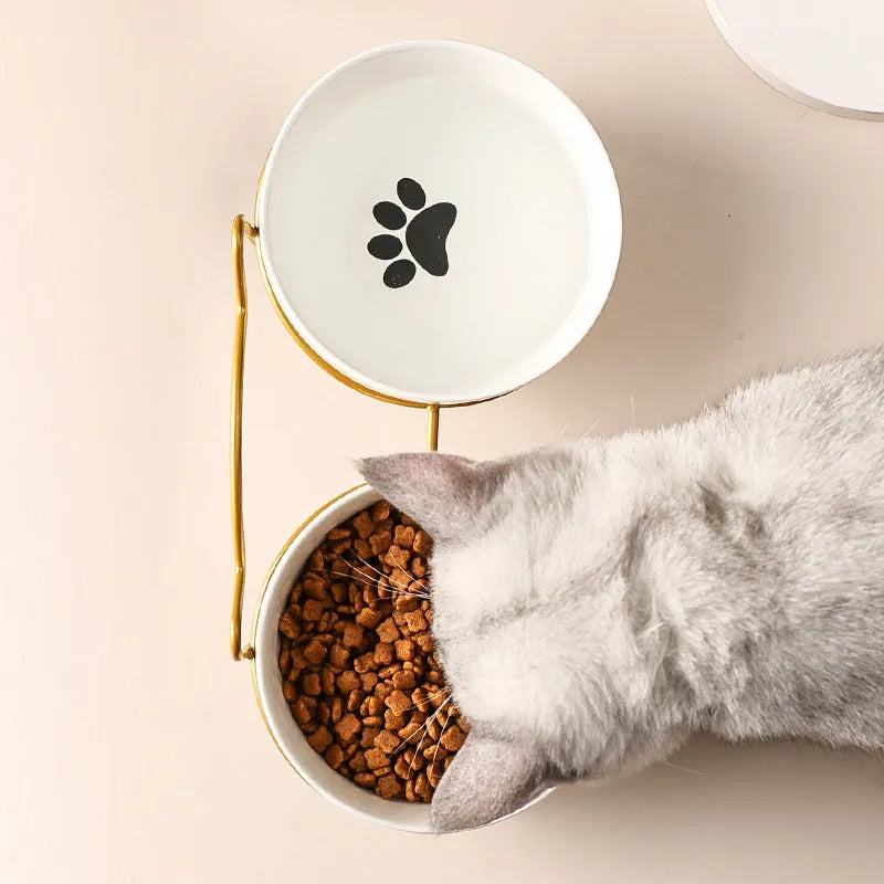 Ceramic cat bowl in an iron frame, showing cat paw print and fishbone pattern options