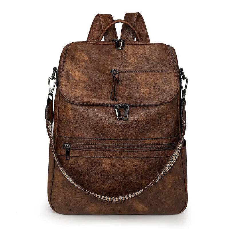 Retro solid colour PU backpack with curved shoulder straps shown in black.