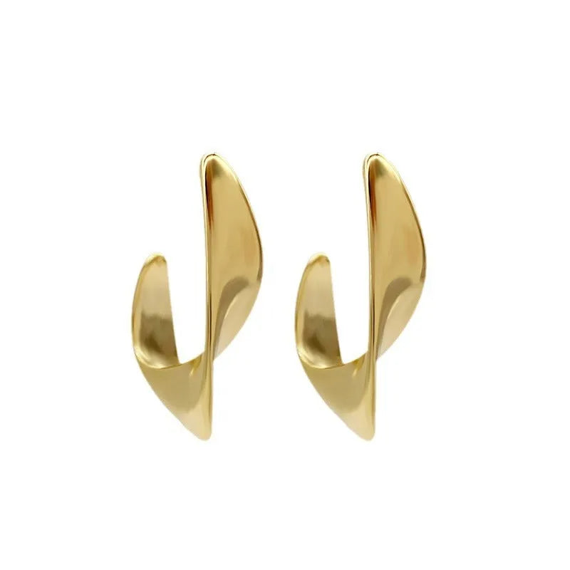 Geometric twist design metal earrings in gold or silver finish with round elements