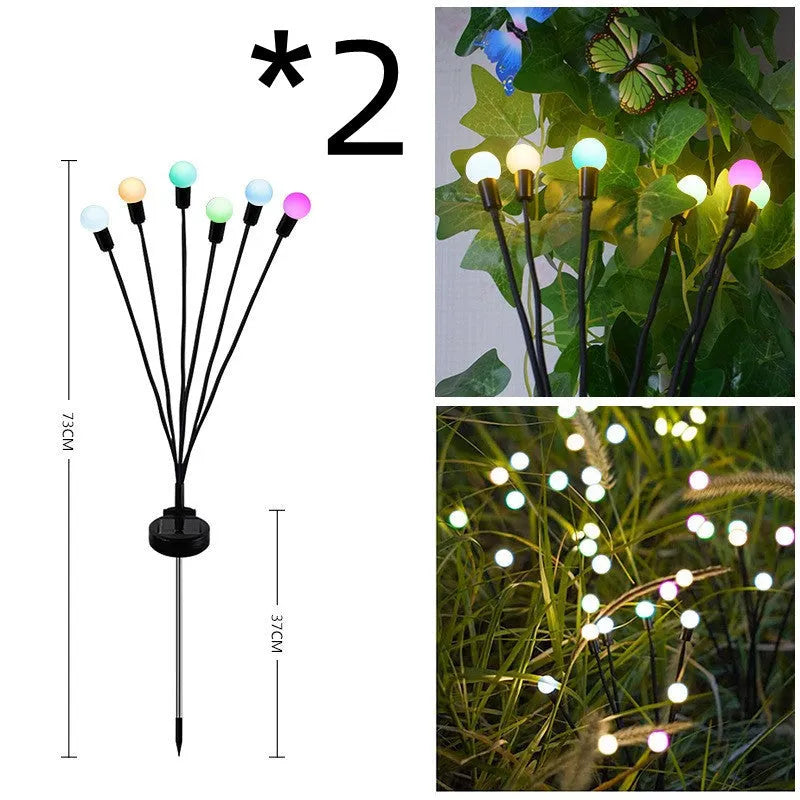 Solar-powered LED firefly garden spike light with multiple heads and a press-in ground plug on grass.
