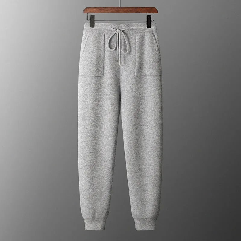 Men's light grey cashmere knitted hoodie and matching long pants casual set laid flat.