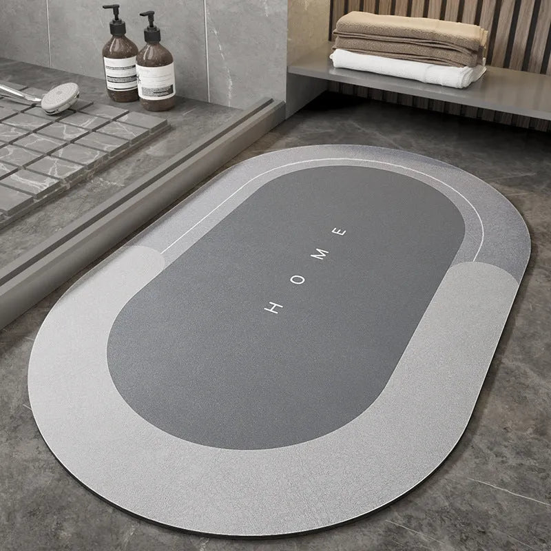 Machine-woven blended bathroom floor mat in blue, shown in an oval shape on a tiled floor.