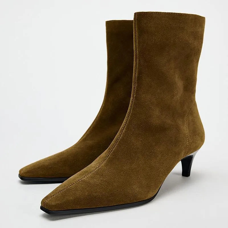 Brown square toe women's ankle boot with a side zip and a mid kitten heel on a plain background.