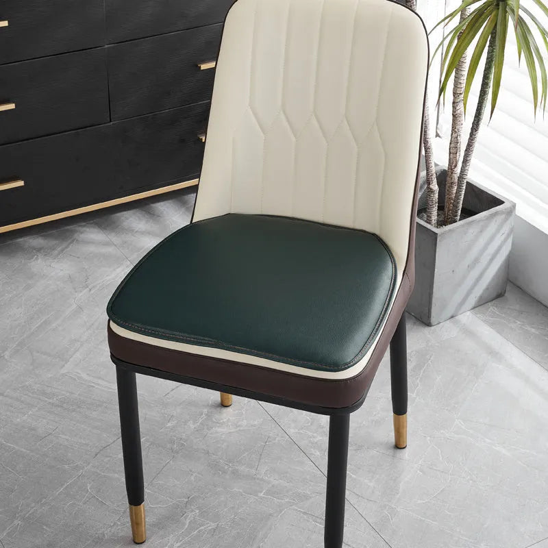 Leather horseshoe-shaped seat cushion in beige colour showing thickness and shape