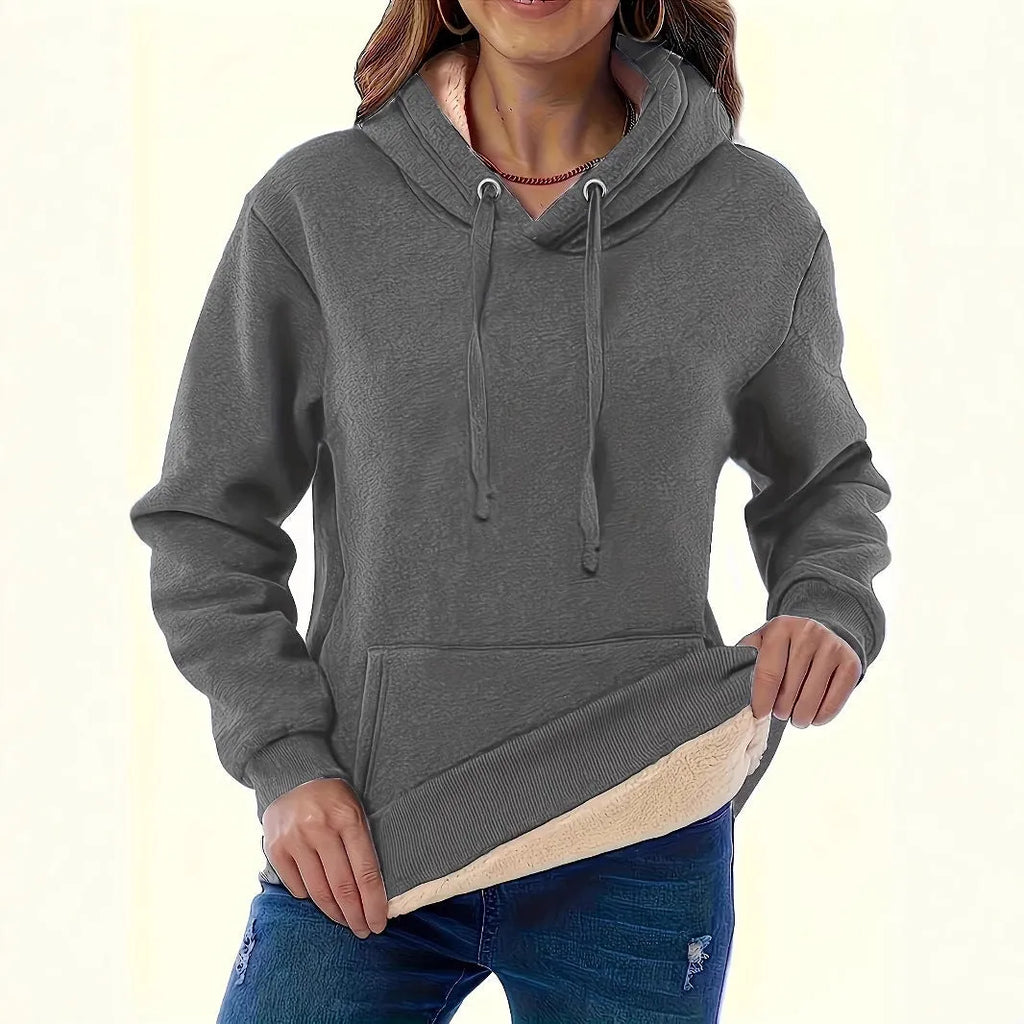 Women's loose hooded sweater with pockets in black colour showing 3D pattern detail