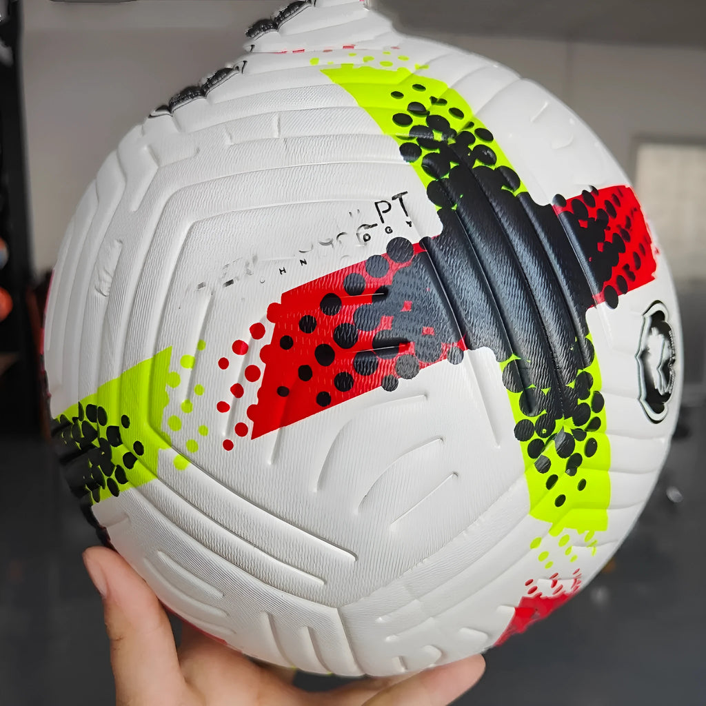 Fluorescent green Size 5 football on a field, showing seamless PU construction.