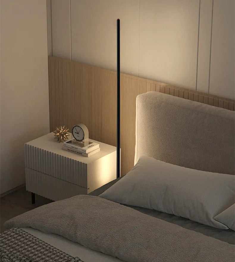 Simple vertical aluminium alloy floor lamp with a USB plug, shown beside a sofa.