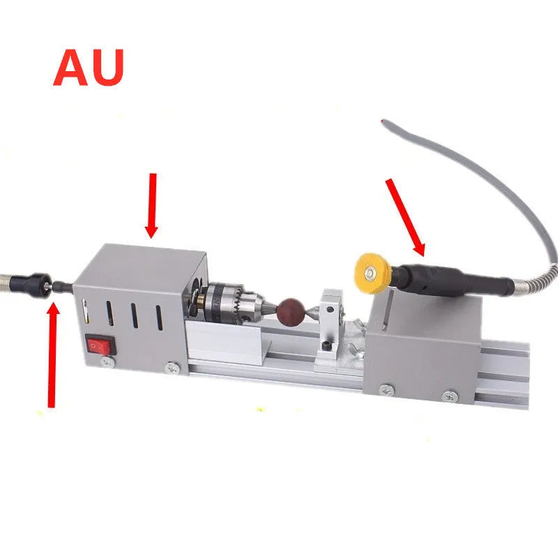 Mini metal woodworking lathe with carving knives and accessories on workbench