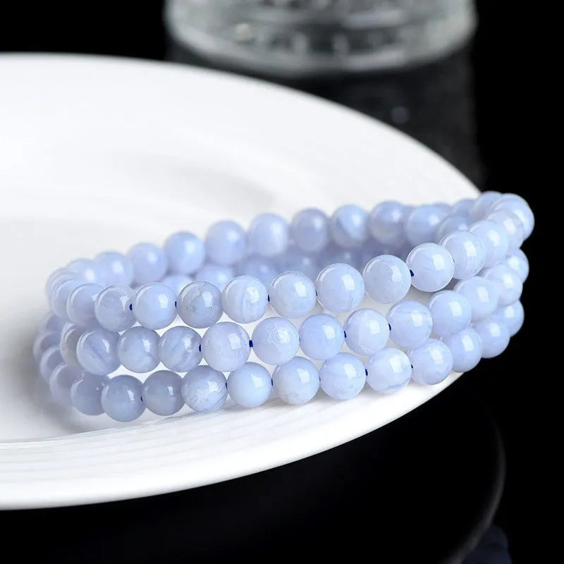 Blue agate bracelet with Ruyi symbol and scattered beads measuring 6-6.8mm.