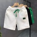 Men's solid colour casual sports shorts with micro elasticity in white, black, or green options