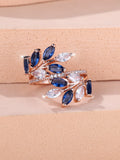 Adjustable copper leaf ring with a central zircon stone on a finger, showing rose gold and platinum colour options.