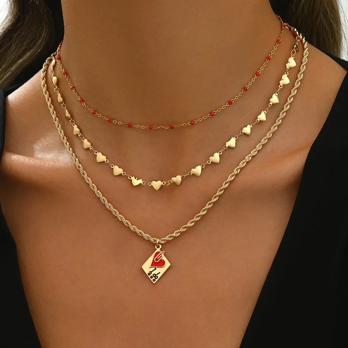 Close-up of a zinc alloy heart pendant on an adjustable three-layer clavicle chain necklace.
