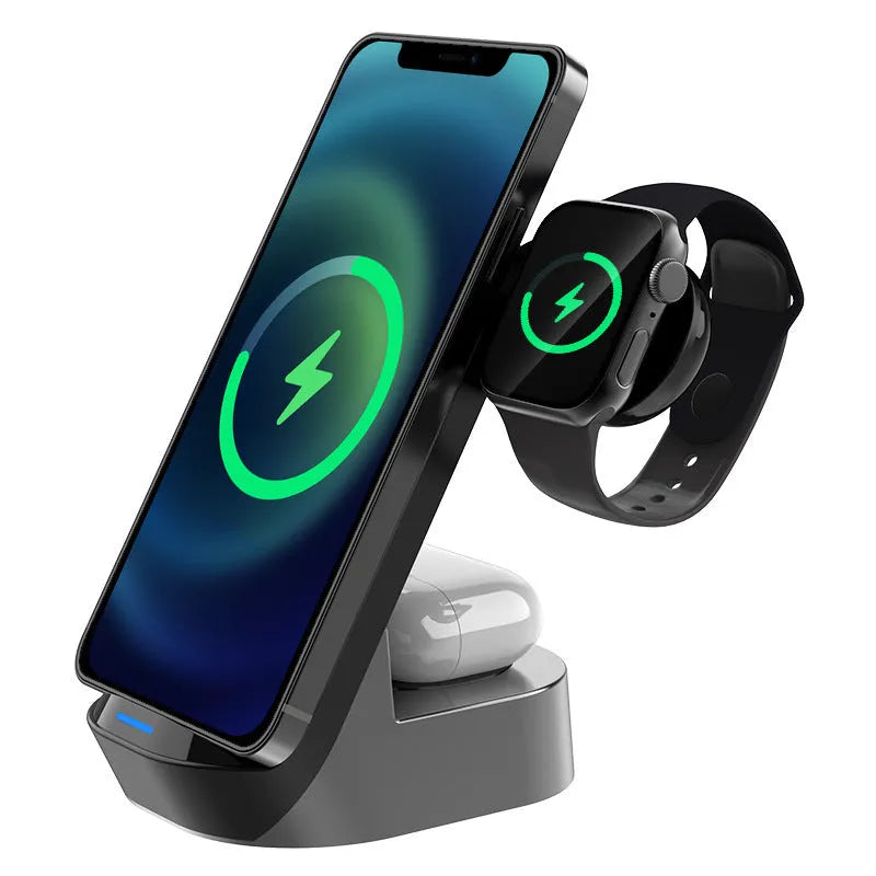 Black grey foldable wireless charging stand holding a mobile phone vertically, with slots for a smartwatch and earbuds case.