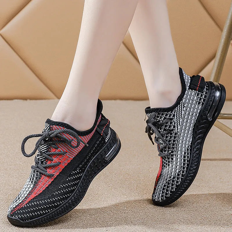 Women's lightweight casual running shoe in purple with front lace-up, round toe, and flat heel.