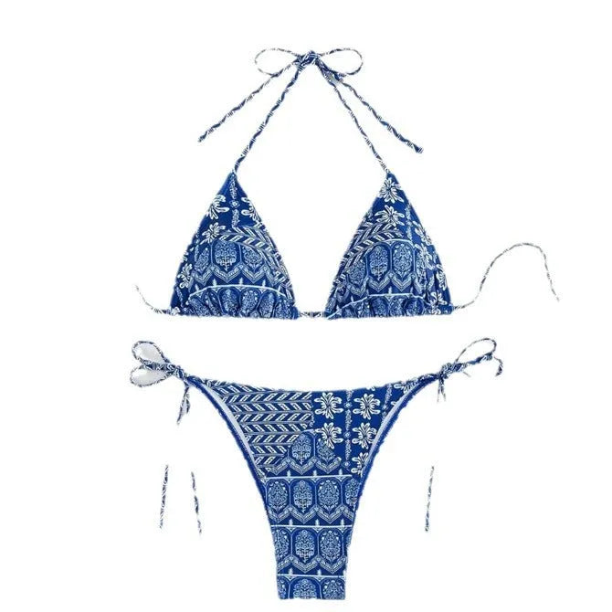 Women's green split bikini swimsuit with bandage-style stitching on a beach.