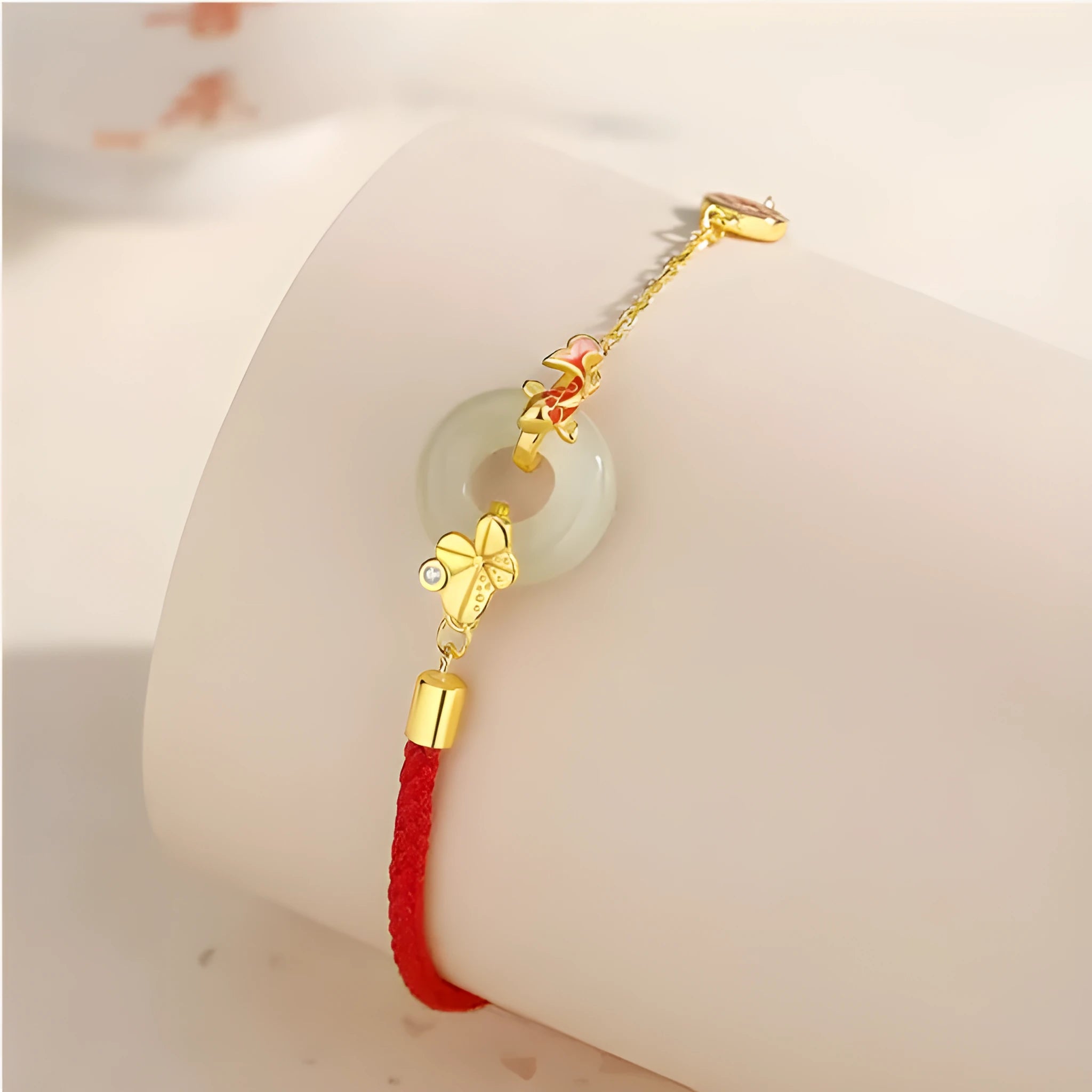Gold-colour Koi fish charm bracelet in 925 silver with a red rope and peace buckle safety clasp.