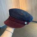 Dark blue denim newsboy hat with octagonal retro design and adjustable sizing