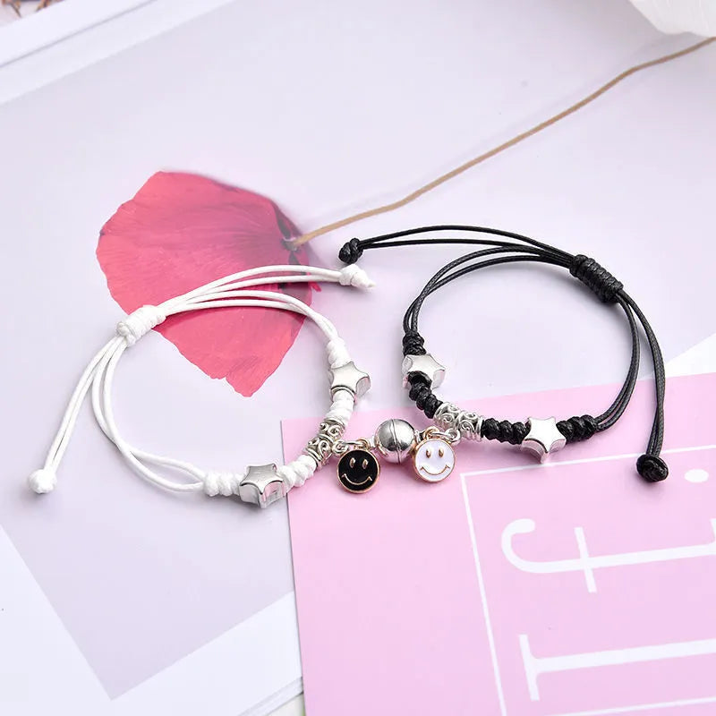 Magnet suction couple bracelets with alloy construction and various pendant designs including crowns and hearts