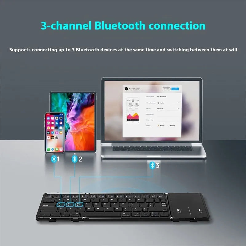 Black folding Bluetooth keyboard showing compact folded size beside mobile phone