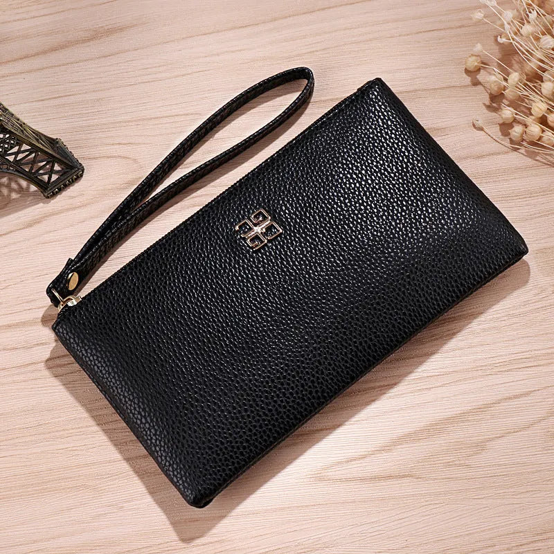 Long slim wine red PU leather wallet handbag with a top zip, shown open to reveal card slots and a phone pocket.