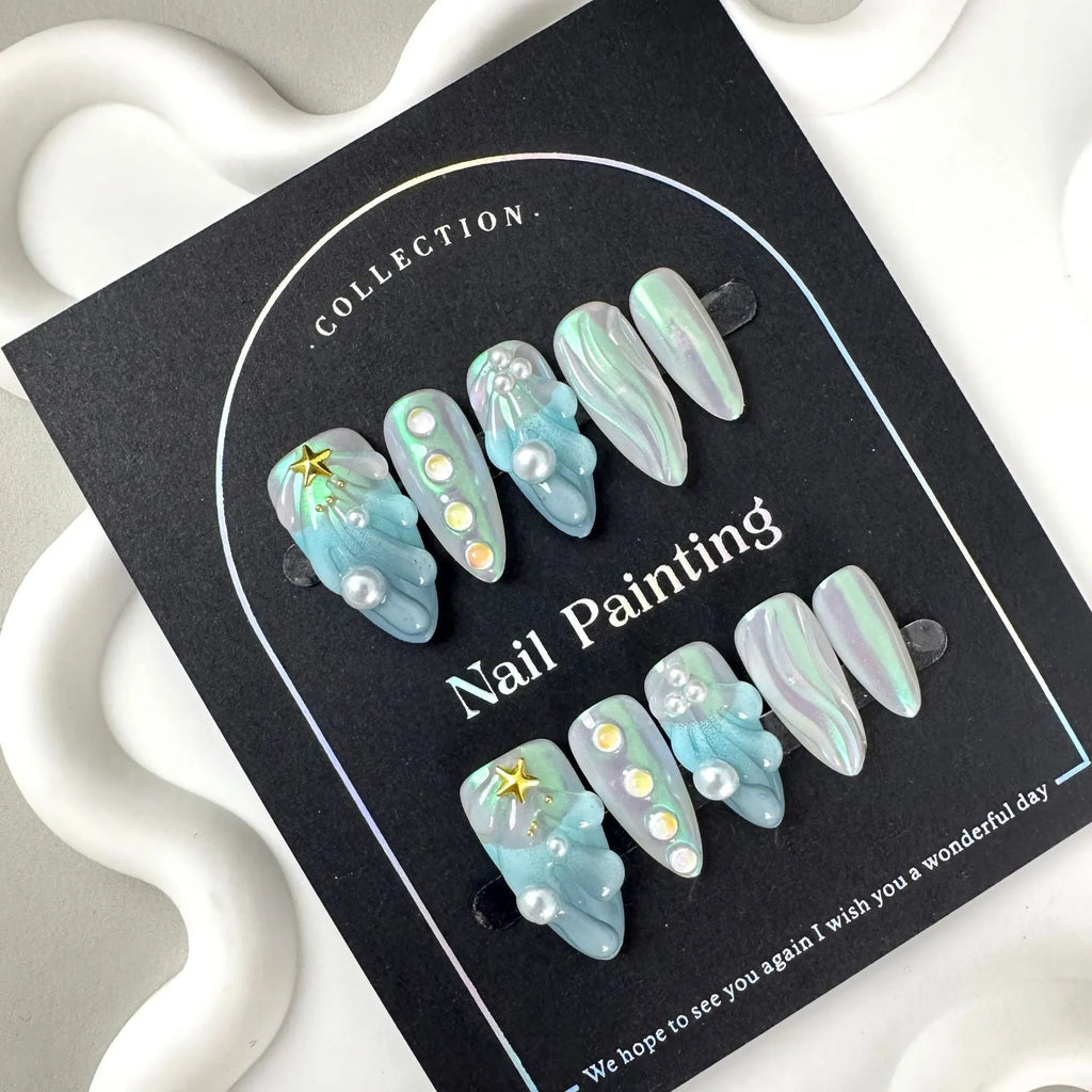 Set of blue plastic shell-shaped nail stickers in sizes XS, S, M, and L