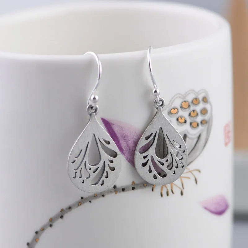 925 sterling silver hollow water drop retro earrings for women, showing grinding texture.