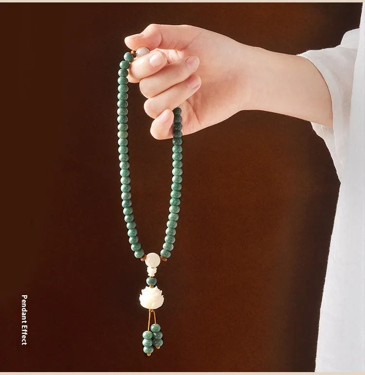 White jade green Bodhi seed bracelet with a safety buckle and lotus charm.