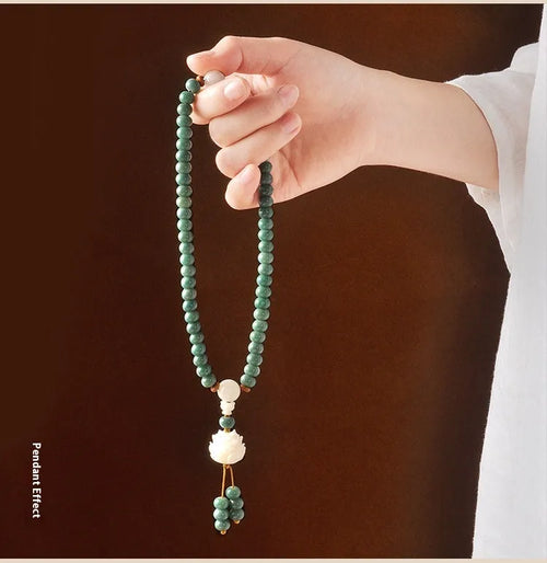 White jade green Bodhi seed bracelet with a safety buckle and lotus charm.