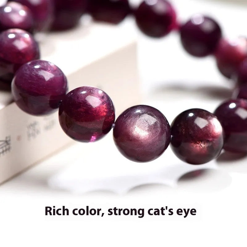 Purple lepidolite crystal round bead bracelet with polished finish and adjustable closure on a wrist.