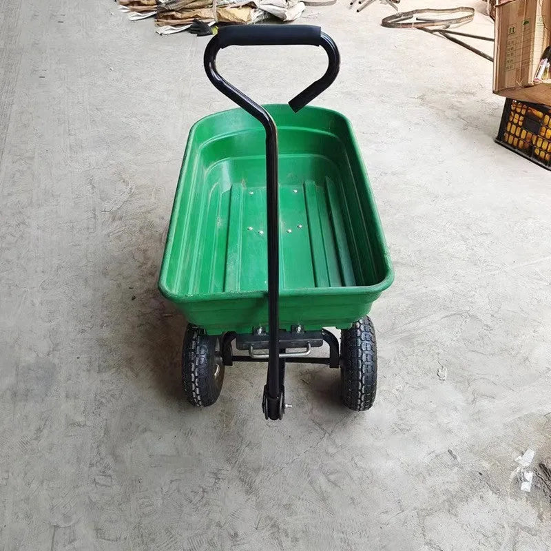 Green four-wheel plastic dump truck with a steel frame and tipping bed for garden and farm use.