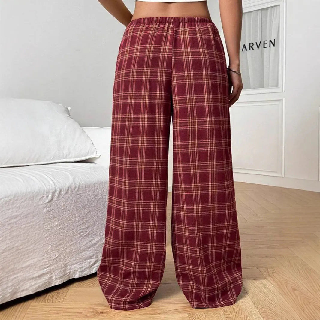 Red plaid women's casual trousers with a drawstring waist and pockets on a hanger.