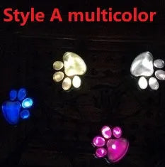 Black solar-powered bear paw print garden lights with four paw shapes and solar panel